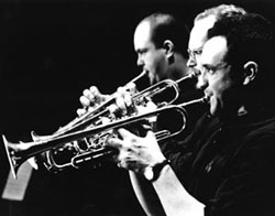 Three Men Playing Trumpets