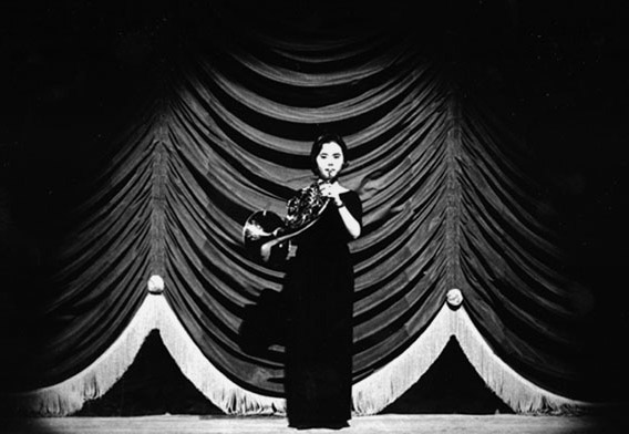 Woman Playing French Horn