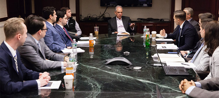 Investment panel members provide feedback after students present their security analysis research during an MDSII Meeting in spring 2018.