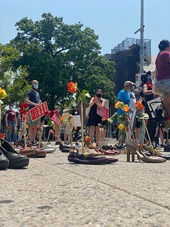 July 2020 protest co-organized by the PSC and ARC, outside the gates of Brooklyn College, with shoes representing faculty and staff who lost health coverage during COVID. Photo by Whitney George