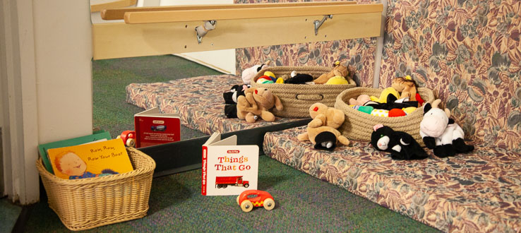 The Infants Room holds comfortable corners where the children can engage in peek-a-boo at the mirror, read books, and play with colorful puppets.