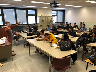 BC Anthropology Club President Chloé Combs welcomes students to the workshop.