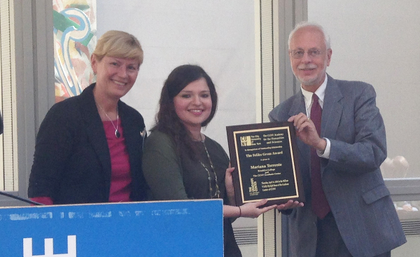 Assistant Professor Mariana Torrente, center, with Professor Malgorzata Ciszkowska, chair of the Department of Chemistry (left), receives the Feliks Gross Award from Manfred Philipp, Executive Director of the CUNY Academy on April 7, 2016.