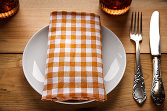 Table setting with plate, fork, knife, and napkin