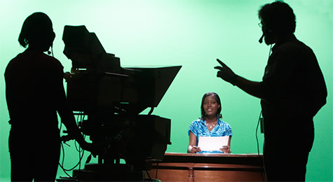 Students practicing their television producing and network reporting skills in a fully equipped studio. Students practicing their television producing and network reporting skills in a fully equipped studio.