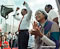 Rosa Parks applauds a speech by Congressman John Conyers (pictured left) at a rally to support labor in Detroit during the late 1980s. Photo by Daymon J. Hartley.