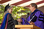 The daughter of famed abstract painter Mark Rothko, Kate Rothko Prizel M.D. '73, is a physician specializing in clinical pathology and transfusion medicine. She gave the keynote speech at the baccalaureate ceremony, held on the college’s Central Quad. In photo, greeted by Provost William A. Tramontano.