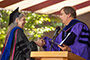 The daughter of famed abstract painter Mark Rothko, Kate Rothko Prizel M.D. '73, is a physician specializing in clinical pathology and transfusion medicine. She gave the keynote speech at the baccalaureate ceremony, held on the college’s Central Quad. In photo, greeted by Provost William A. Tramontano.
