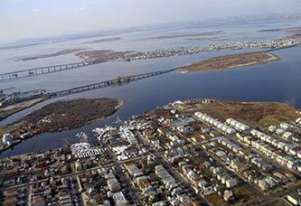 An aerial view of Jamaica Bay highlights how surrounding neighborhoods are impacted by the condition of the bay and reliant on its fortification. An aerial view of Jamaica Bay highlights how surrounding neighborhoods are impacted by the condition of the bay and reliant on its fortification.