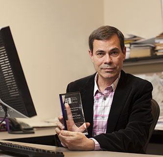 Carlos A. Cruz, the multimedia, instructional deisgn specialist and Blackboard/Sakai administrator at the Brooklyn College Library, showing his award.