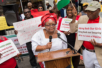 Okome addresses a rally in midtown Manhattan. 