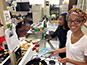 <p>Health and nutrition major Patricia Pauyo, who is the treasurer of the Health and Nutrition Club, fries cassava with the club’s vice president Naudia Jones in the Food Science Laboratory.</p>