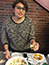 <p>Health and nutrition major Sally Hawana from Alexandria, Egypt, serves <em>ful</em>, a dish made with fava beans at the Open Kitchen luncheon. </p>