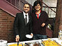 <p>Computer science major Mojahed Ahmed (l) and master’s candidate in business and economics Majed Gushgari, both from western Saudi Arabia, serve a spiced chicken-and-rice dish called <em>kabsa</em>.</p>