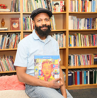 Javaka Steptoe with his latest book about Jean-Michel Basquiat.