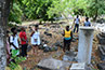 <p>The Chief of the Charlestown Maroon Community shows the BLMI group the cemetery where the Maroon ancestors are buried.</p>