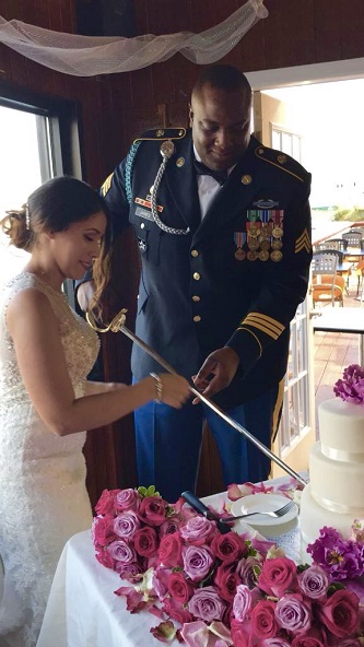 <p>The highly decorated James, in full regalia, and his wife Damaris Rosado-James '10, use his saber to cut their wedding cake at a ceremony that took place on September 30.</p>