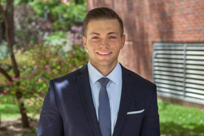 Graduating senior Sebastian Komuda stands proudly in front of Whitehead Hall, where most of the School of Business' courses take place. He is the most recent winner of the MDSII Security Analysis Program Award. Photo: David Rozenblyum.