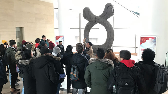 Students visiting southwest China’s Yangzhou museum with a tour guide, who is talking about two figures: Fu Yi and Nu Wa in Chinese mythology who were said to have created the earliest Chinese people.