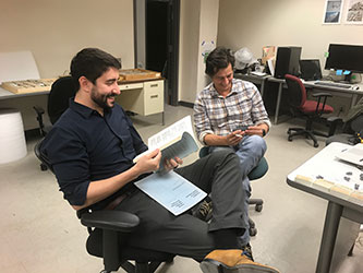Co-authors Stephen Chester <em>(left)</em> and Gregory Wilson Mantilla examine <em>Purgatorius</em> fossils at the University of California Museum of Paleontology. Photo by Patricia Holroyd