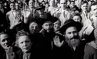 A photo of a mass naturalization at Ebbets Field in Brooklyn from November 11, 1954, is part of Brooklyn College’s Library Archives and Special Collections new Hasidism in America Film project.