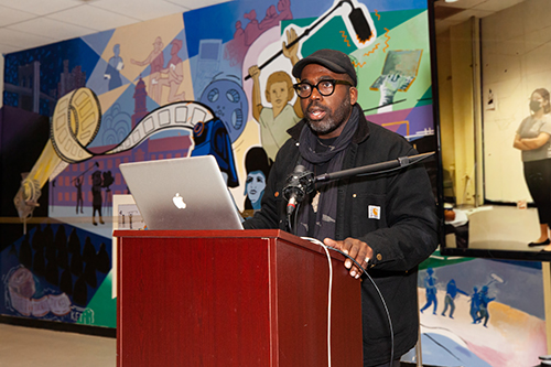 Derrick Adams, an accomplished mural artist and Professor of Art who served as an advisor on the mural project, addresses the audience on December 14.