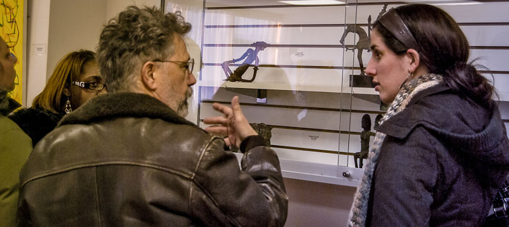 Students and professors discuss the Art Gallery's exhibits.