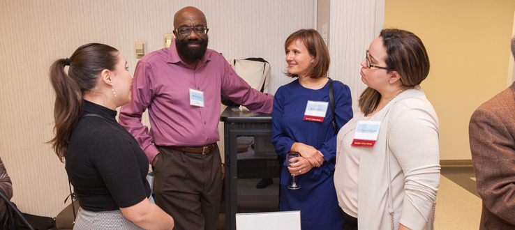 Students, alumni and faculty mingling. 