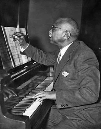W.C. Handy composing at the piano, courtesy of <a href=