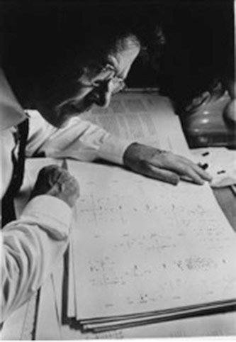 John Cage, studying the score of <em>Atlas Eclipticalis</em> (1961) Photographer: Unknown Courtesy of the John Cage Trust