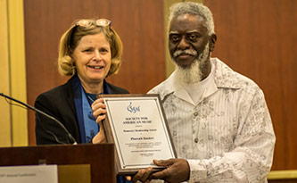 Pharoah Sanders receiving SAM’s highest award from SAM President Kitty Preston. Photo by Michael Broyles.