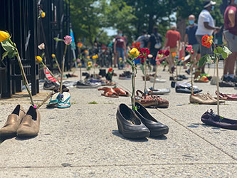 July 2020 protest co-organized by the PSC and ARC, outside the gates of Brooklyn College, with shoes representing faculty and staff who lost health coverage during COVID. Photo by Whitney George