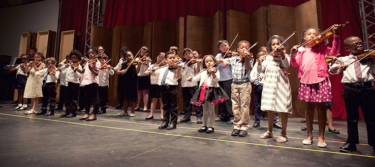 Our Suzuki program violin students at one of their special performance events.