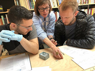 Professor Britt working with students in her lab with historic artifacts from various contexts of New York City, exposing students to archaeological methods and the rich history of the city.