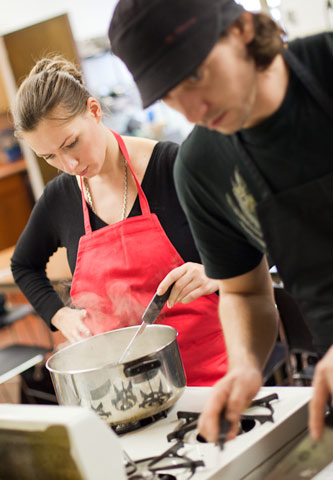 Students work in teams as they create meals in the on-campus kitchen.