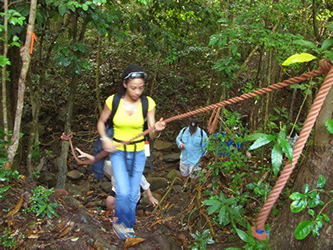 Jen-I Costosa '13 utilizes mountain climbing equipment during a hike to an archaeological dig in Barbuda.
