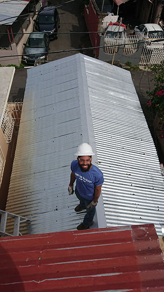 Senior Jonathan Cabral working on a rooftop in Puerto Rico.