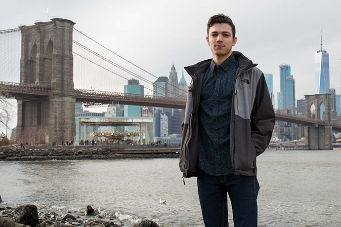 With Wall Street, the Brooklyn Bridge, and the Freedom Tower as his backdrop, Moshe 'Moe' Farah stands proud as a member of the Brooklyn College Class of 2018.