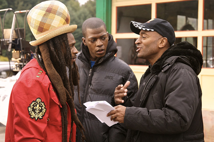 On the set of his award-winning documentary <em>Rocksteady</em>, Khan (right) talks with reggae legend David Hinds of the critically acclaimed band Steel Pulse.