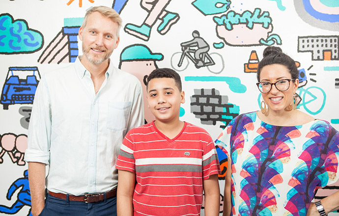Burgess, Mamoud Ali, and Nuzzo are all smiles in front of the mural that exemplifies joint effort. Photo by Craig Stokle.